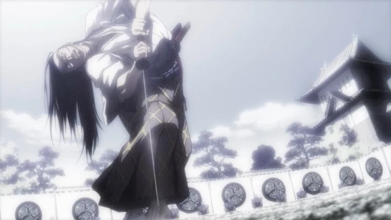 An anime image from the series Shigurui: Death Frenzy showing a swordsman, likely Irako Seigen, holding another figure in a dramatic pose outside a traditional Japanese building. The scene depicts the intense, dark martial arts drama of the Edo era story.