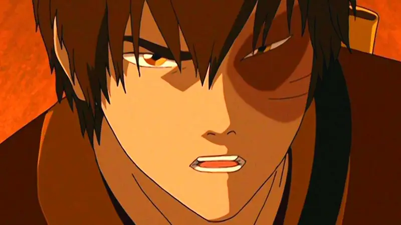 A close-up shot of the character Zuko from Avatar: The Last Airbender. He has a serious, intense expression with a prominent burn scar over his left eye.