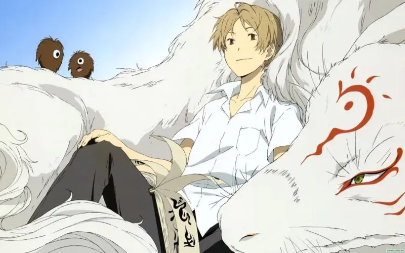 An illustration of the character Takashi Natsume from the anime Natsume's Book of Friends sitting with the large white fox-like form of Nyanko-sensei and two small brown fluffy spirits.