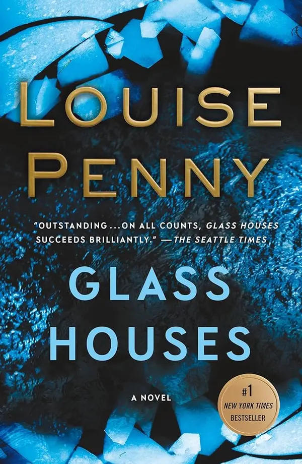 Book cover for "Glass Houses" by Louise Penny, featuring a dark background with blue and white shattered glass fragments. Text on the cover includes the author's name, the book title, a blurb from The Seattle Times ("OUTSTANDING... ON ALL COUNTS, GLASS HOUSES SUCCEEDS BRILLIANTLY."), and a gold seal indicating it is a #1 New York Times Bestseller.