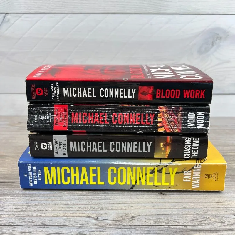 Four Michael Connelly novels stacked horizontally: Blood Work, Void Moon, Chasing the Dime, and Fair Warning.