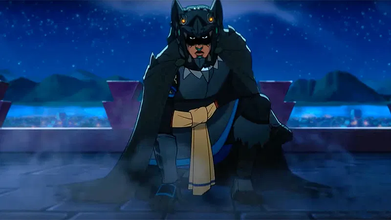The image is a still from the animated film Aztec Batman: Clash of Empires, featuring the main character in his full costume. The character is Yohualli Coatl, a young Aztec boy who takes on the mantle of the bat god Tzinacan to fight against the Spanish conquistadors who murdered his father. The image depicts him in his unique, Mesoamerican-inspired dark suit and headpiece, crouching dramatically at night. The film reimagines the Batman legend within the vibrant culture of 16th-century Mesoamerica. 
