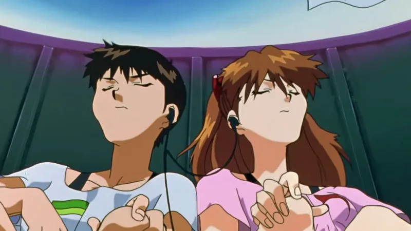 A still from the anime Neon Genesis Evangelion showing characters Shinji Ikari and Asuka Langley Soryu sitting side-by-side with their eyes closed, sharing a pair of wired earphones 