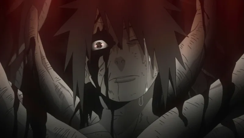 This image captures the moment Obito Uchiha, a character from the anime series Naruto: Shippuden, is in a state of despair and rage after witnessing the death of his teammate, Rin Nohara. This moment is a turning point for his character, leading him down a path of villainy. 