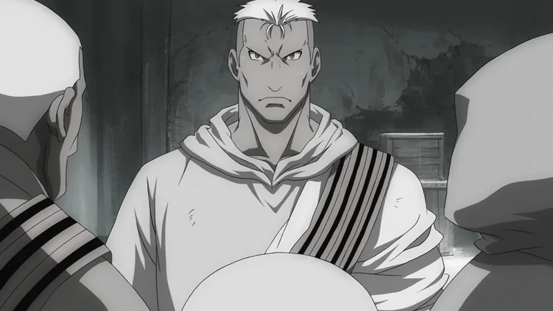 A black and white still from the anime Fullmetal Alchemist: Brotherhood showing the character Scar. The image features the character known as Scar, a nameless lone serial killer and revolutionary from the series. He is an Ishvalan who targets State Alchemists for revenge for his slaughtered people. He is known for his distinctive hair and the large scar on his face. 