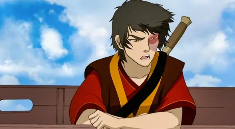 Prince Zuko from Avatar: The Last Airbender sitting down, looking angry or contemplative, showing his burn scar and sword scabbard.